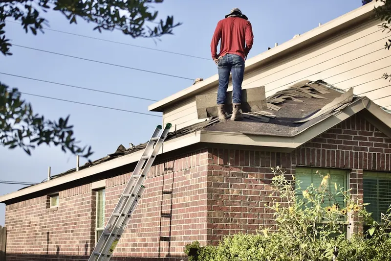 Professional roofer working on a residential roof in Hartwood